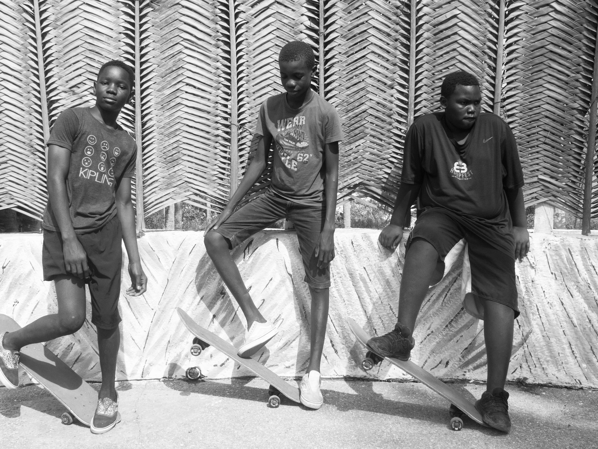 An image of three young skate-boarders