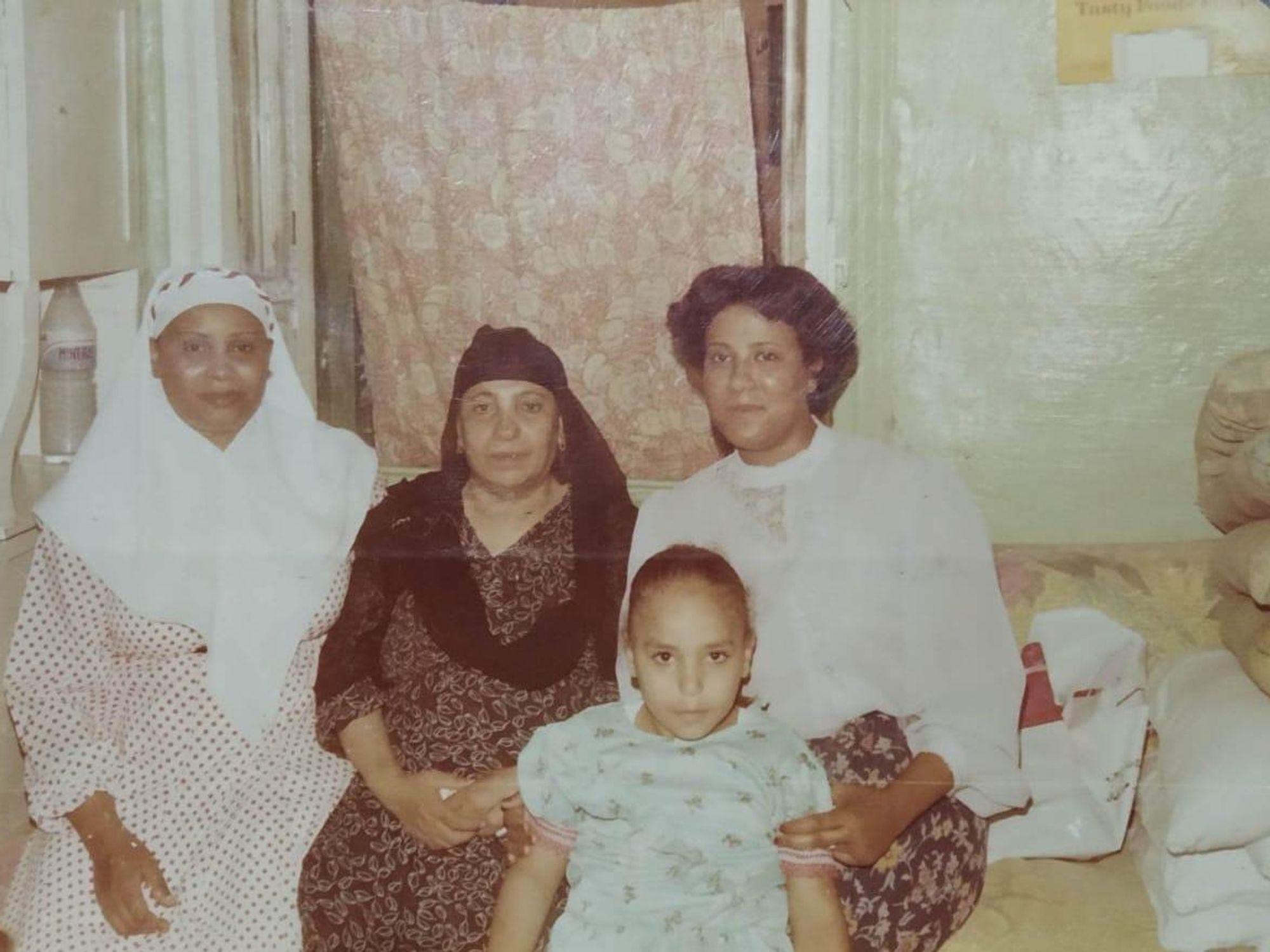 An old family photo of the Tareks in Egypt sitting side by side. 