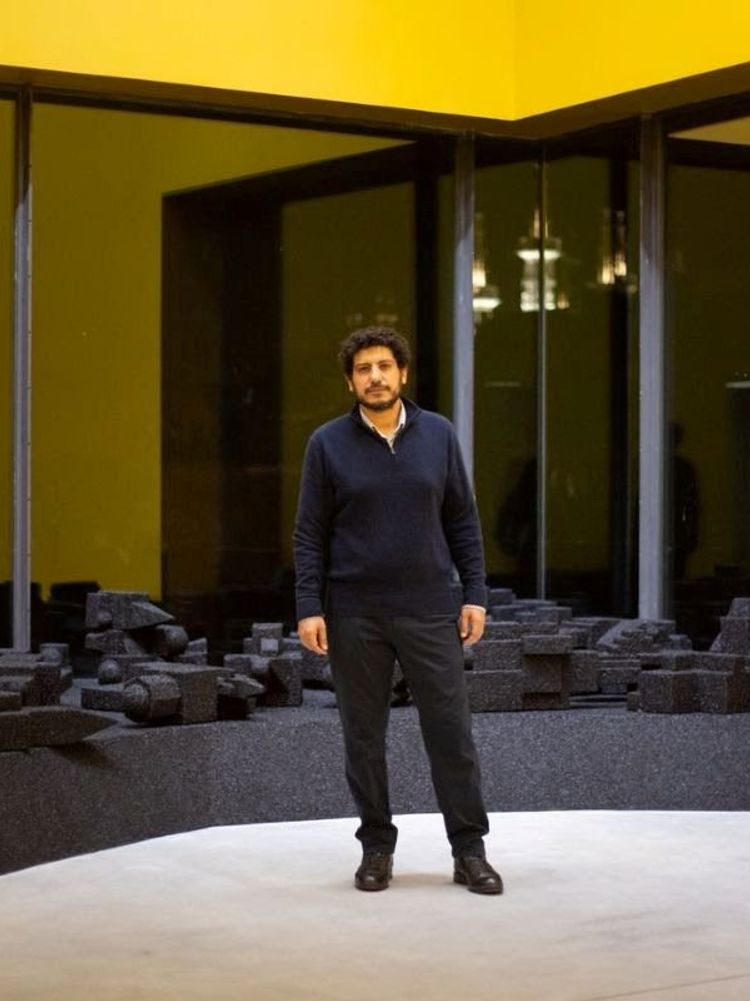 Artist Wael Shawky stands in front of one of his installations. 