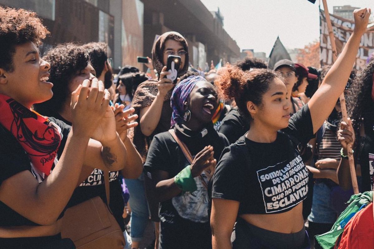 Black Chilean feminists marching with raised fists