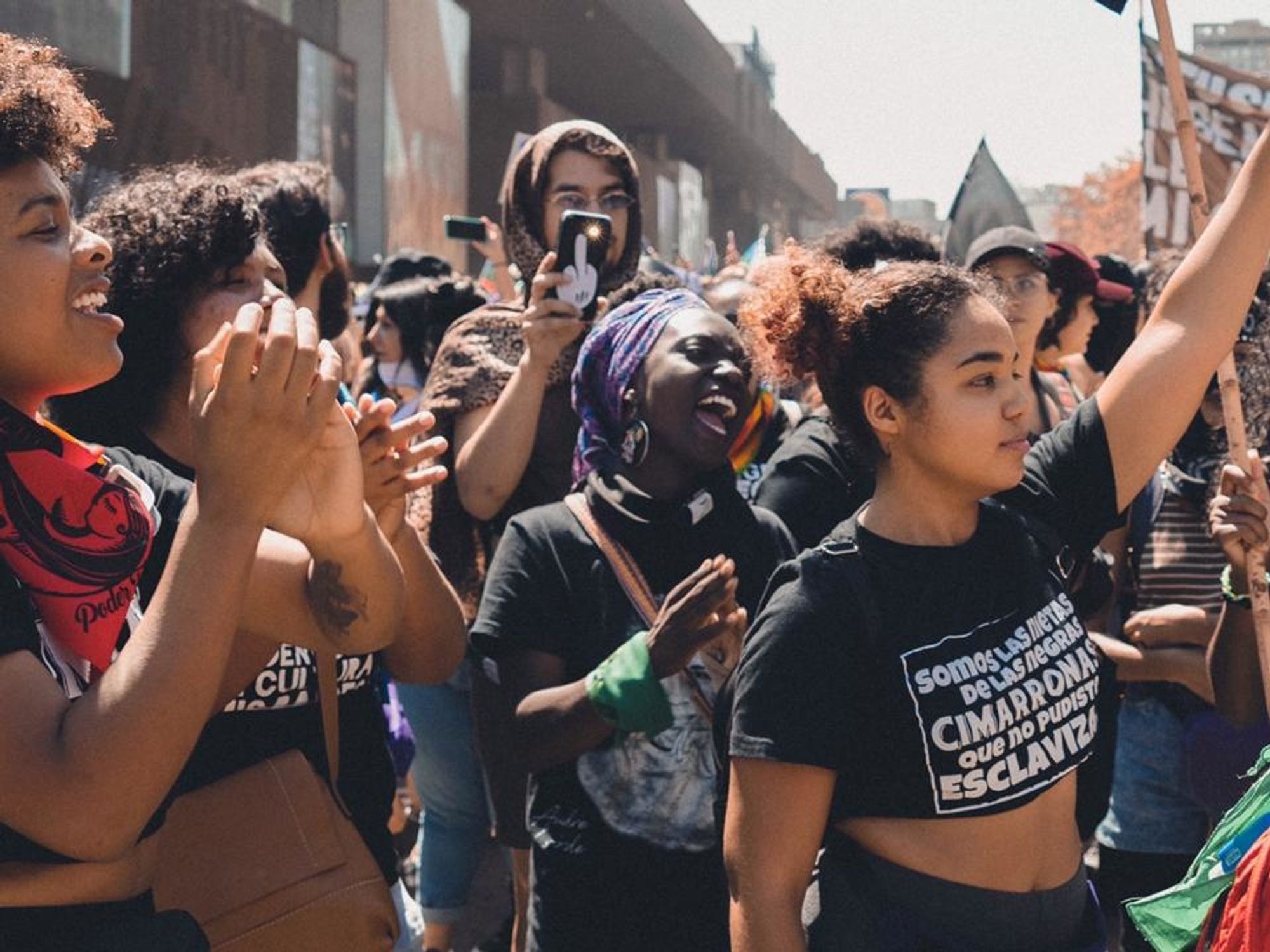 Black Chilean feminists marching with raised fists