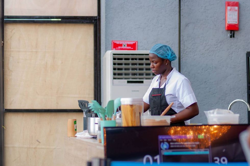 black woman cooking in kitchen