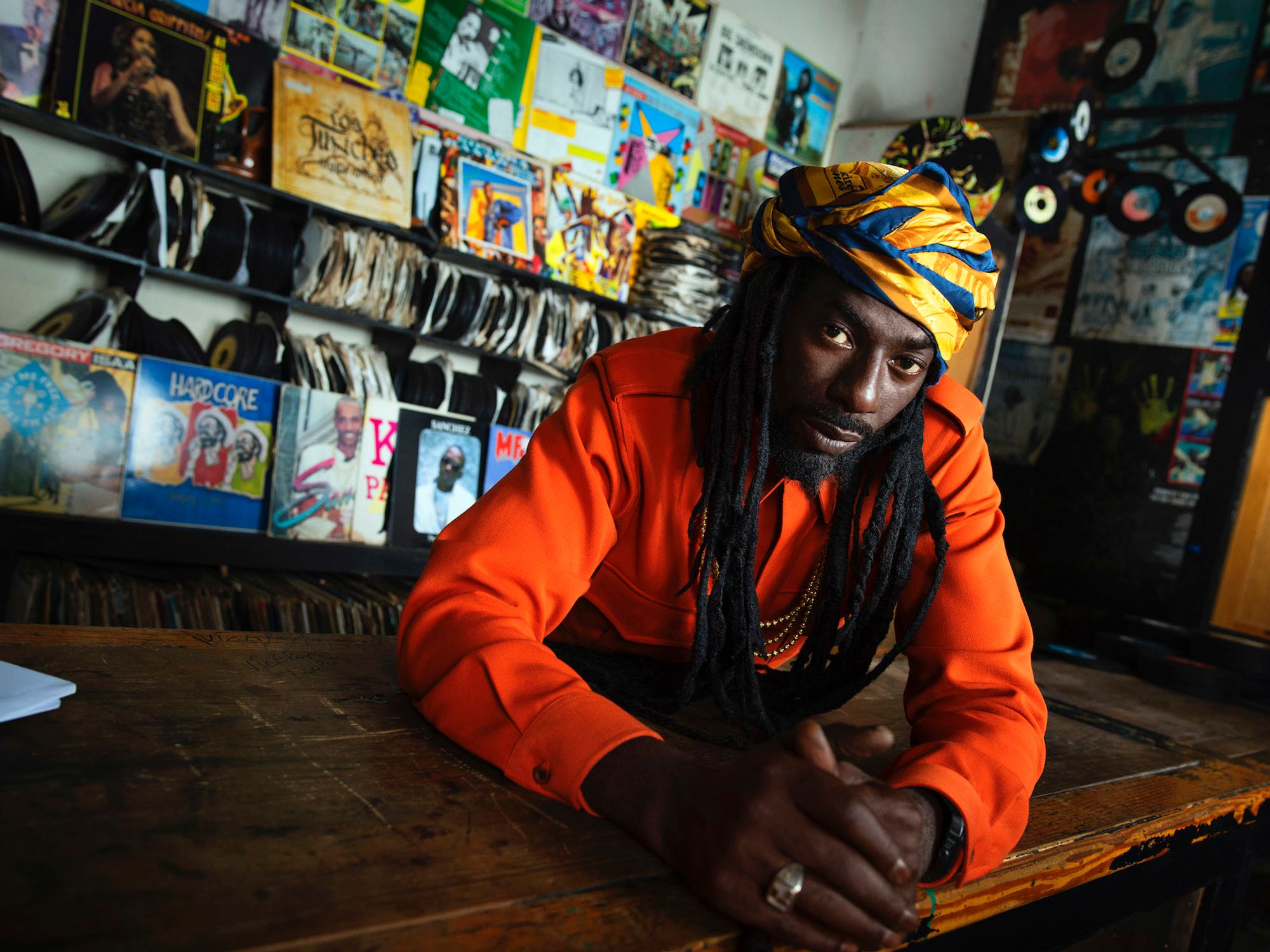 Buju Banton sits in a record store.