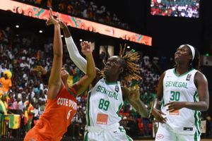 Côte d'Ivoire's Tracy Yomy  jumps for the ball against two Senegal players