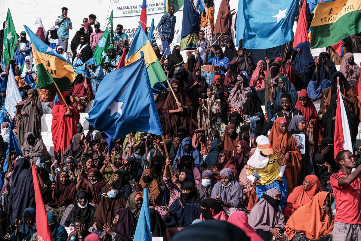 Demonstrators hold flags during a rally against the Al-Shabaab jihadist group in Mogadishu on January 12, 2023. - Somalia's President Hassan Sheikh Mohamud has declared "all-out war" against Al-Shabaab, which has been waging a bloody insurgency against the frail internationally-backed federal government for 15 years.