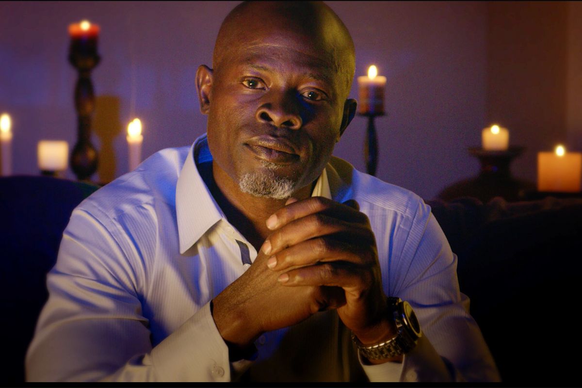 Djimon Honsou looking into camera. Still from in search of voodoo.