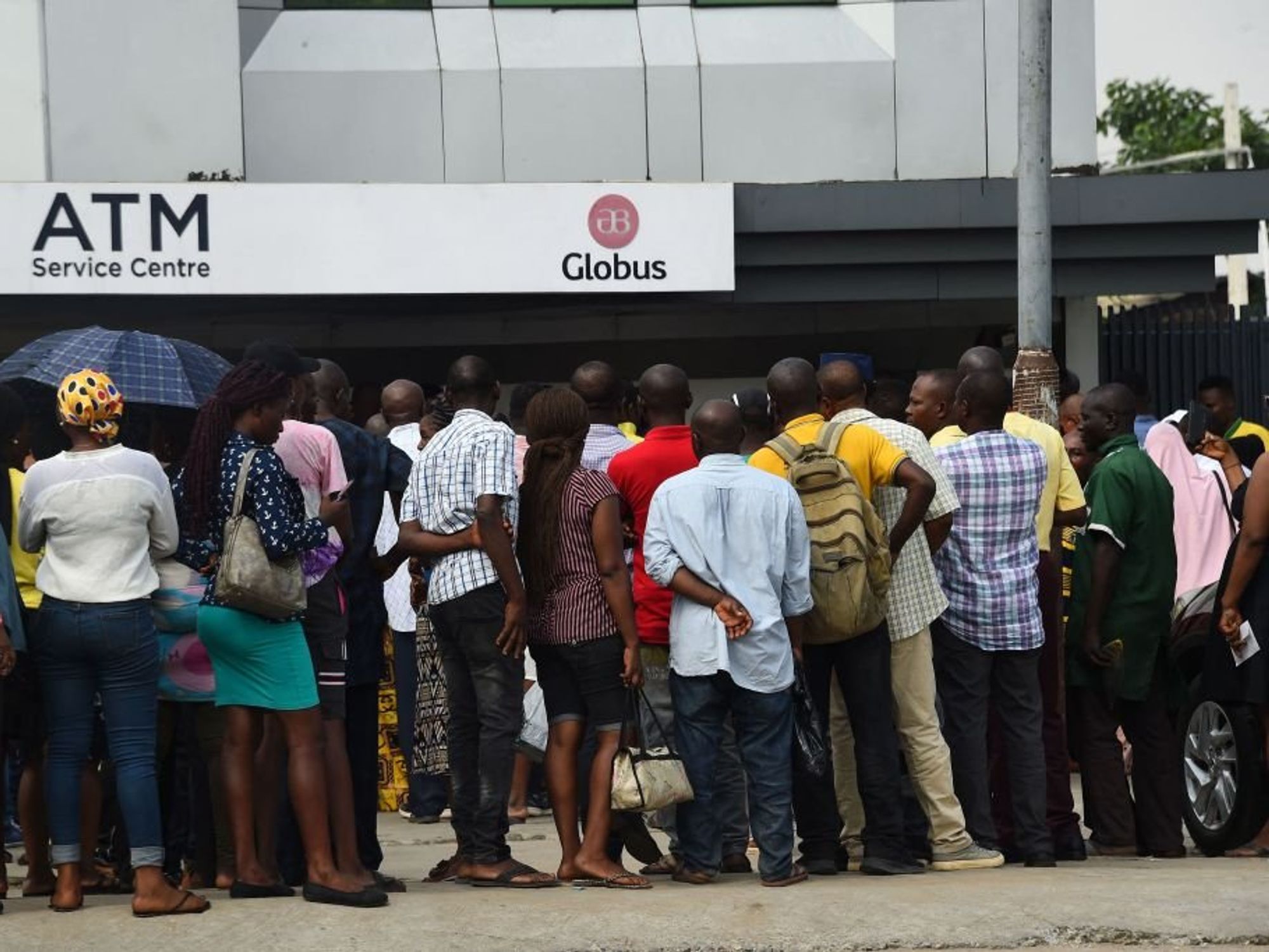 Dozens of Nigerians in a queue outside the bank.