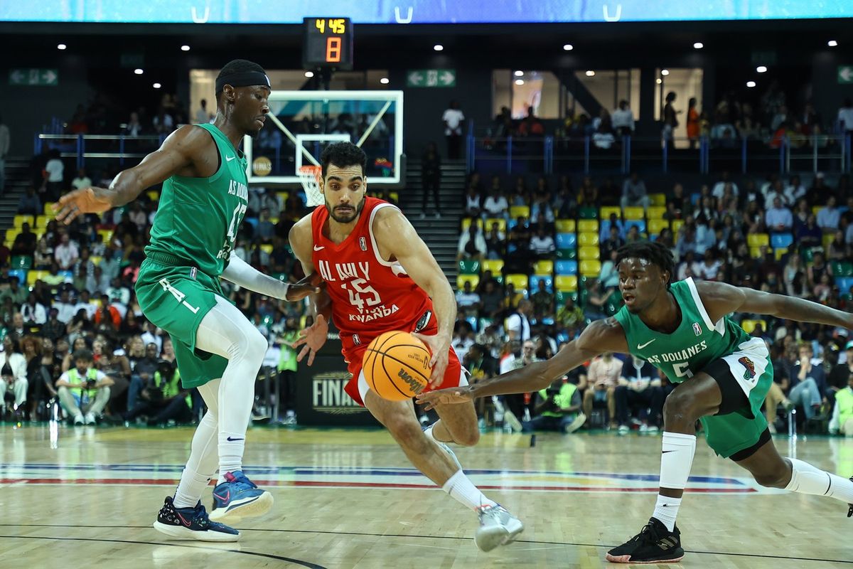 Ehab Amin (C) of Al Ahly and Jean Jacques Boissy (R) of AS Douanes compete during the 2023 Basketball Africa League Championship match between AS Douanes and Al Ahly at BK Arena in Kigali, Rwanda on May 27, 2023.