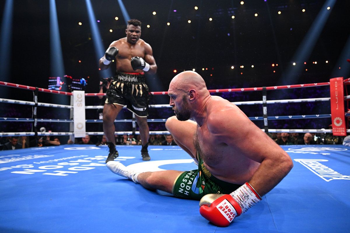 Francis Ngannou knocks down Tyson Fury during the Heavyweight fight between Tyson Fury and Francis Ngannou at Boulevard Hall on October 28, 2023 in Riyadh, Saudi Arabia.