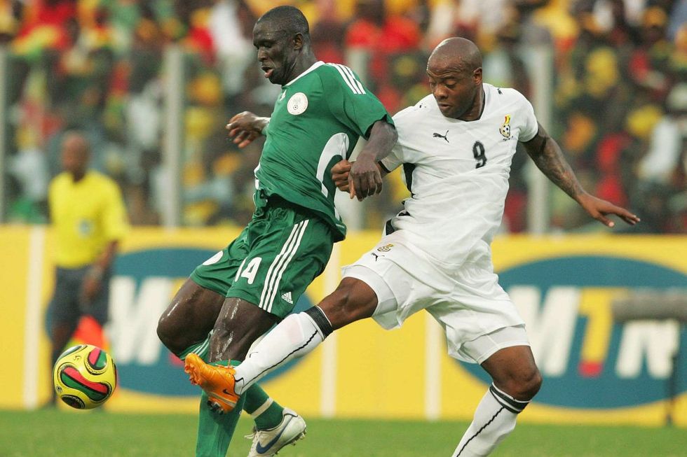 George Olofinjana is tackled by Manuel Agogo during the quater final AFCON match between Ghana and Nigeria held at the Ohene Djan Stadium on February 3, 2008 in Accra, Ghana.
