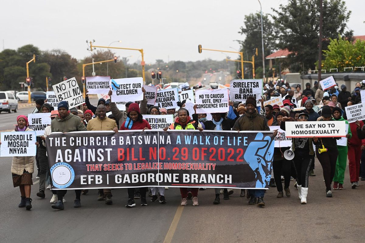 Graphic content / Demonstrators from the Coalition of Botswana Christian Churches chants slogans against homosexuality and hold placards while marching toward the Parlament of Botswana on July 22, 2023 protesting against legislation seeking to make same-sex relation legal.
