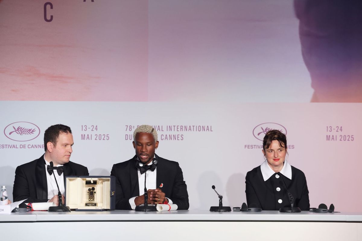 Hasan Hadi, Akinola Davies, and Alice Rohrwacher sitting at a conference table with mics in front of them.