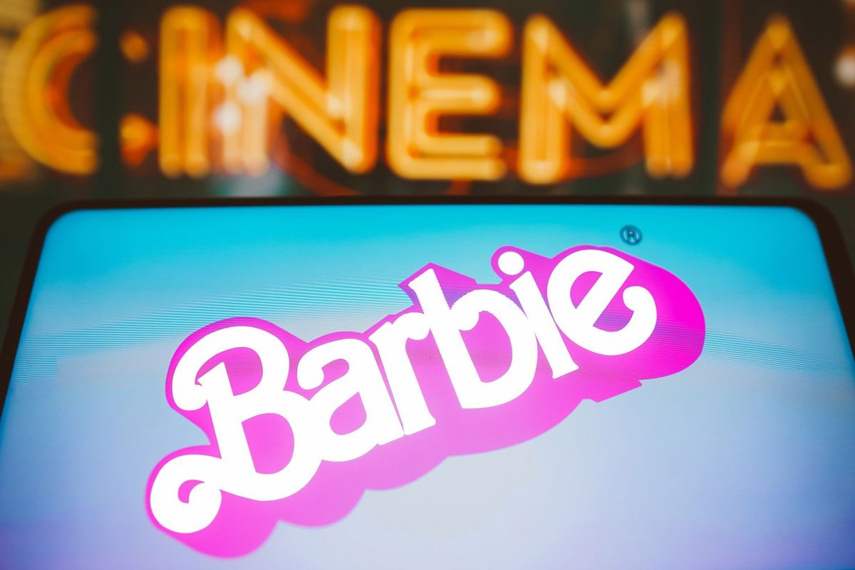 I​n this photo illustration, the Barbie the movie logo is seen displayed on a smartphone.