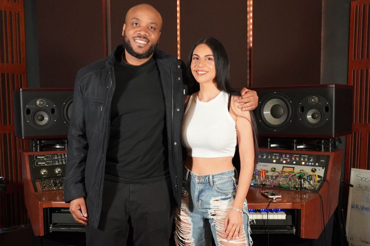 Ikenna wears all-black, and Chrissy rocks a white tee and denim as they pose for a picture