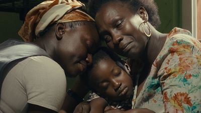An image from the film of three people hugging each other. 