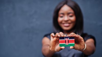 Woman holding Kenyan flag in the shape of a card