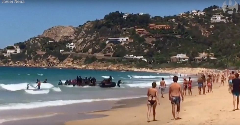 This Clip of Spanish Beachgoers Watching as an African Migrant Boat Lands Will Put Things In Perspective