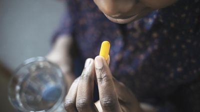 Black woman eating pill