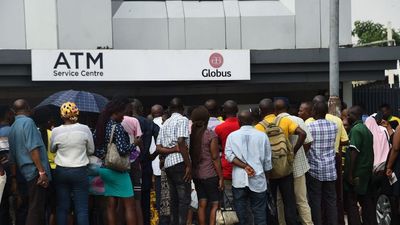 Dozens of Nigerians in a queue outside the bank.