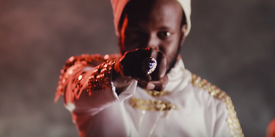 Zim Dancehall star Winky D making a fist to the camera from his video "Dissapear."