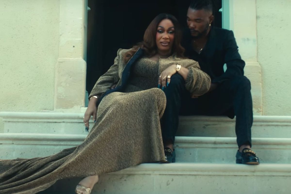 Ivorian music legend Josey is pictured leaning into her partner for the music video of her latest song.