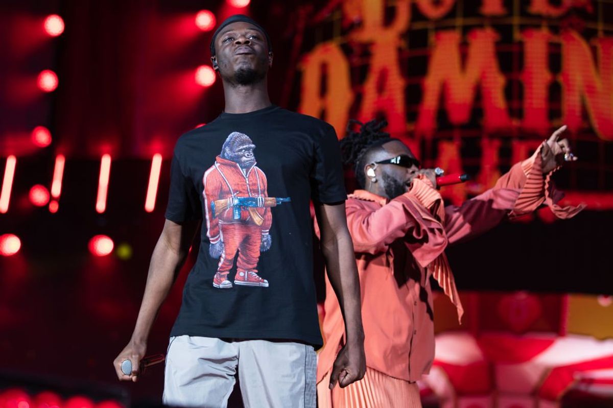 J hus performs onstage with burna boy