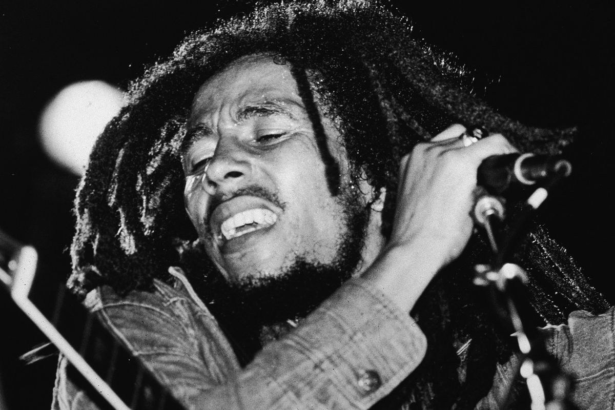 Jamaican reggae musician Bob Marley (1945 - 1981) performs on stage, a microphone in his hand, late 1970s. 