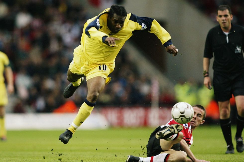 Jay-Jay Okocha of Bolton Wanderers is sent flying by the challenge from David Prutton of Southampton during the FA Barclaycard Premiership match held on May 3, 2003 at the St Mary's Stadium, in Southampton, England. The match ended in a 0-0 draw.