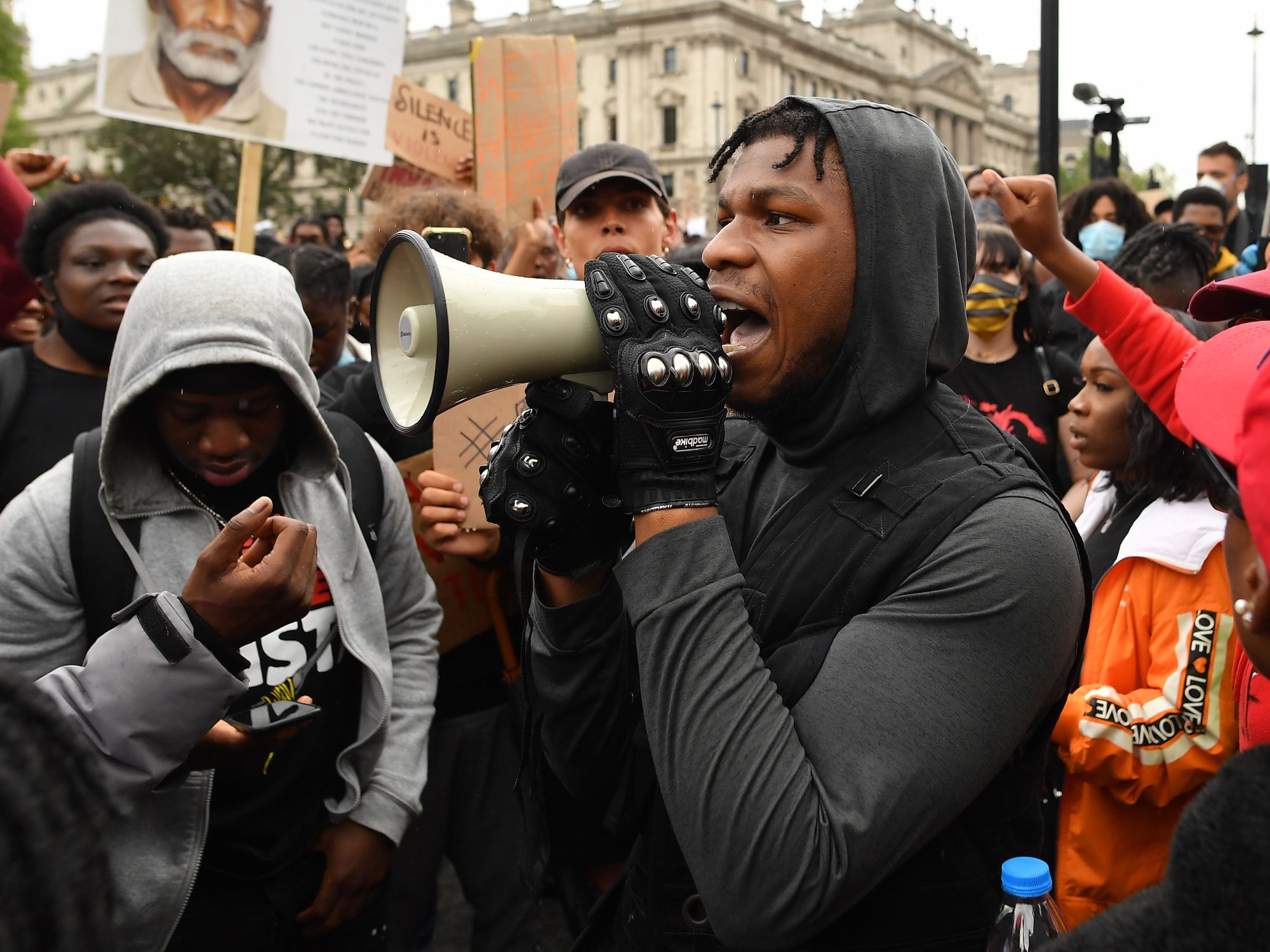 John Boyega at protest with megaphone.