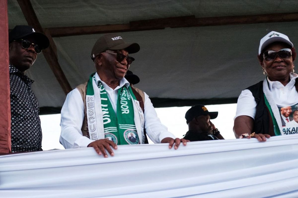 Joseph Boakai (C) leader of the main opposition party, the Unity Party (UP), stands in the back of a lorry during his final campaign rally in Monrovia on October 7, 2023. Liberians are scheduled to head to the polls for a general election on October 10, 2023. 