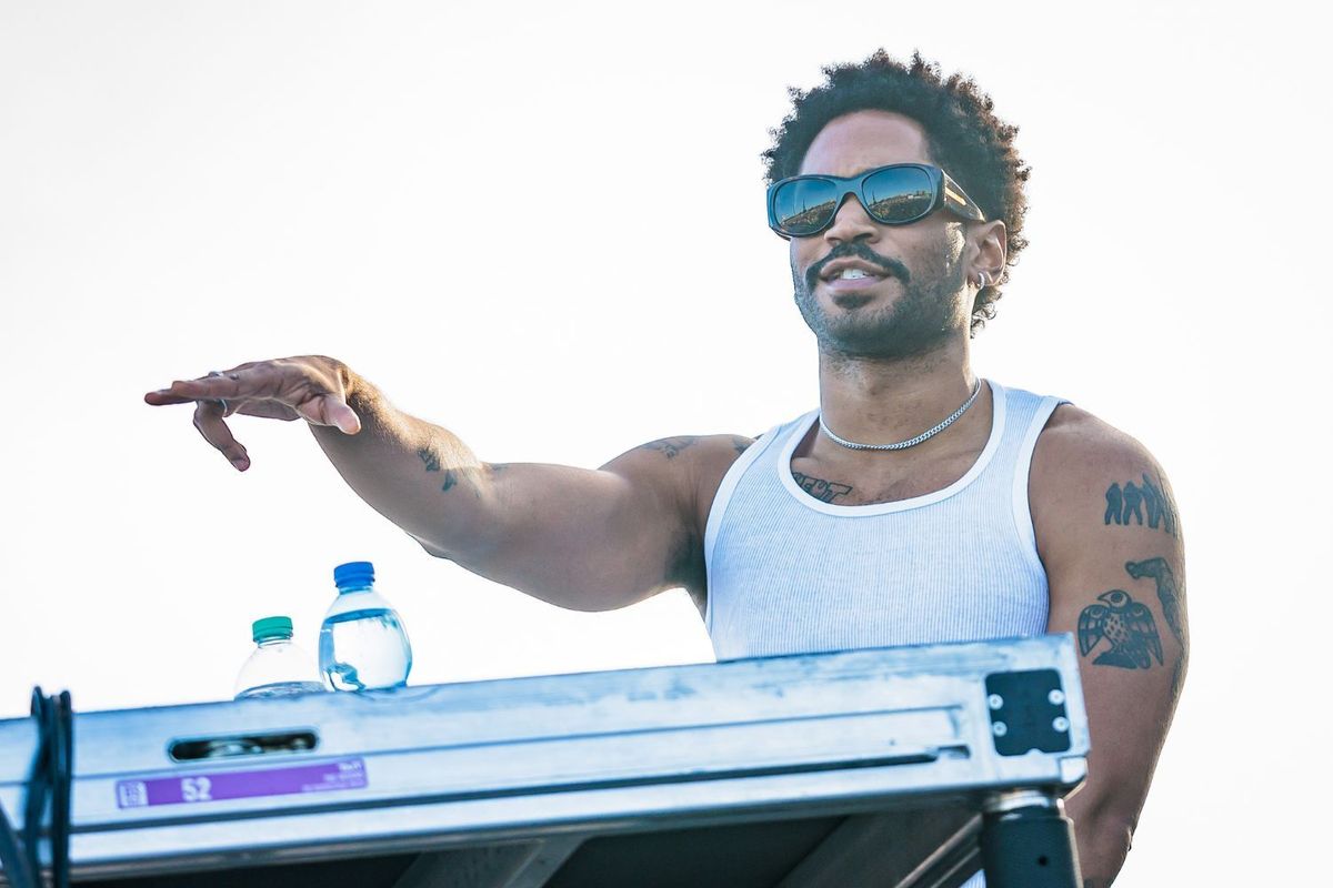 Kaytranda stands in front of a DJ set, performing