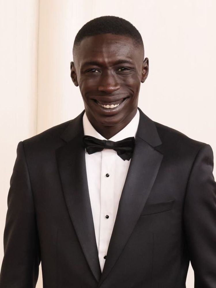 Khaby Lame poses for a photo in a black tuxedo at the 96th Annual Academy Awards on March 10, 2024 in Hollywood, California.