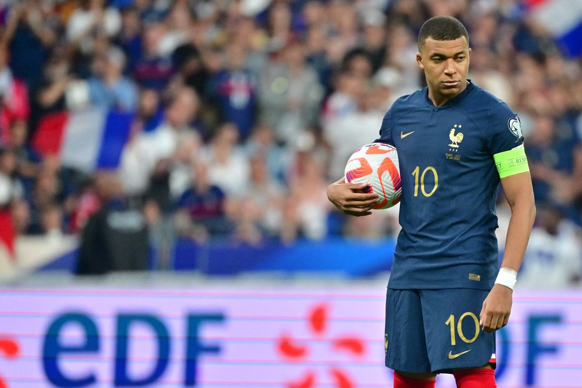 Kylian Mbappe of France grabs the ball during the UEFA EURO 2024 Qualifying Round match between France and Greece at Stade de France on June 19, 2023 in Saint-Denis, near Paris, France. 