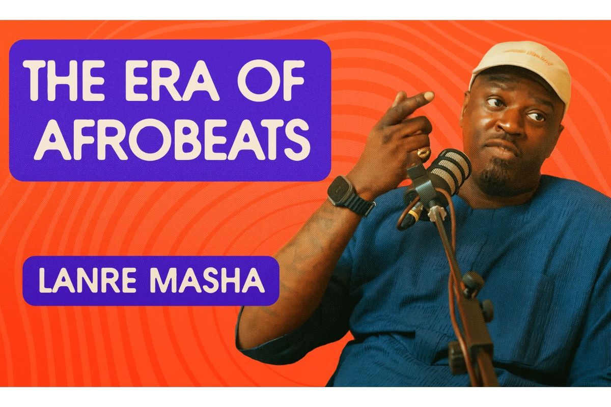 Lanre Masha sits in front of a pod mic, gesticulating.