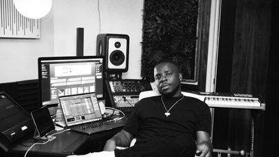 1srael the producer behind future and tems wait for u sits at his production desk.