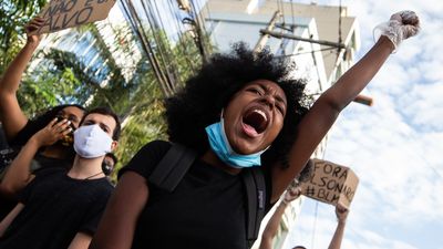 Brazilian Black Lives Matter activist marching in Sao Goncalo with Afro.