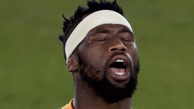 A still from the documentary of Siya Kolisi with his eyes closed, looking up with his mouth open wide. 