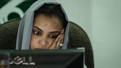 A Sudanese woman works at a travel agency in Khartoum on June 17, 2019 as businesses struggle to keep their services going after being hit by an internet blackout.