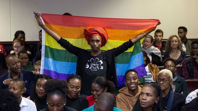An image of an activist holding up a rainbow flag inside the Botswana High Court. 