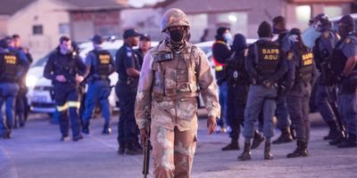 Man in army fatigues and South African police during the coronavirus lockdown.