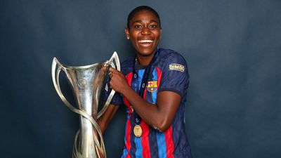 Asisat Oshoala of FC Barcelona poses for a photograph with the UEFA Women's Champions League trophy after the UEFA Women's Champions League final match between FC Barcelona and VfL Wolfsburg at PSV Stadion on June 03, 2023 in Eindhoven, Netherlands.