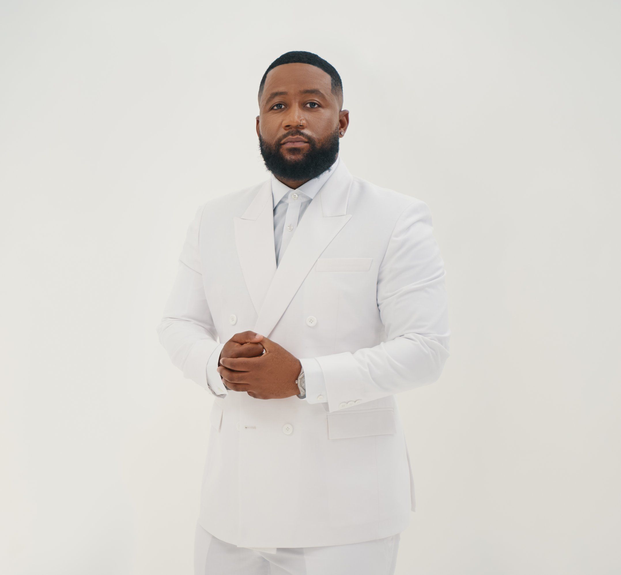 Black man wearing white suit