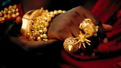 Close up of an Akan king's hand showing traditional Ashanti rings made of pure gold. Such displays of wealth are a common sight at Durbars, traditional gatherings of royalty, throughout Ghana in West Africa.