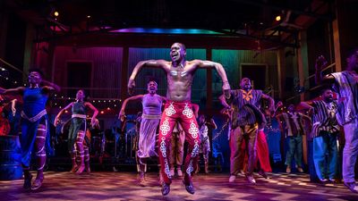 An image of the actor Duain Richmond jumping on stage as Fela. 