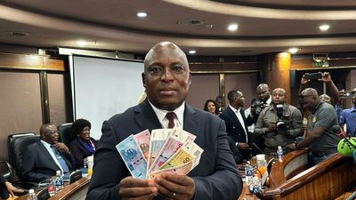 A photo of John Mushayavanhu, Governor of the Reserve Bank of Zimbabwe, presenting the new national currency Zimbabwe Gold, or ZiG for short, at a press conference on April 5, 2024.