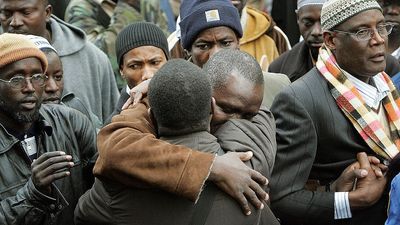 Pictured: Gambian community members comfort each other as they mourn those lost in the Jan 9th Bronx fire