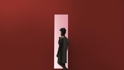 woman walking into red door