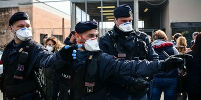 Italian police in face masks direct crowds amid the coronavirus epidemic.