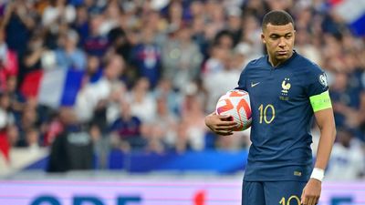 Kylian Mbappe of France grabs the ball during the UEFA EURO 2024 Qualifying Round match between France and Greece at Stade de France on June 19, 2023 in Saint-Denis, near Paris, France. 