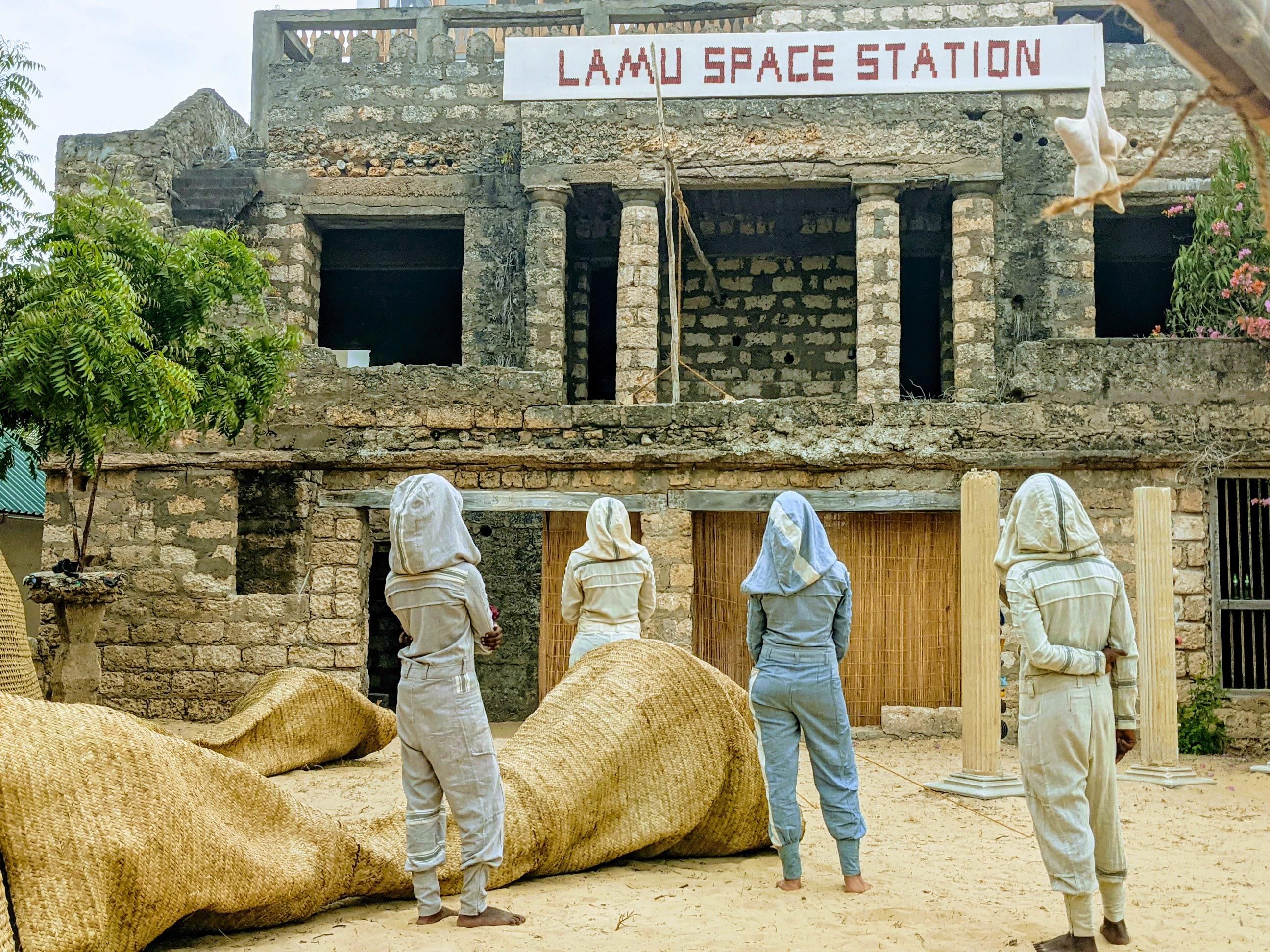 An image of artists standing in front of the Lamu Space Station art gallery in Kenya